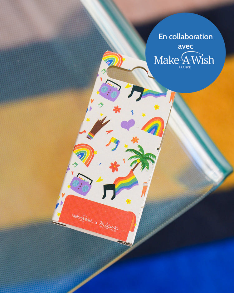 Boîte à musique avec motif coloré et manivelle visible.
