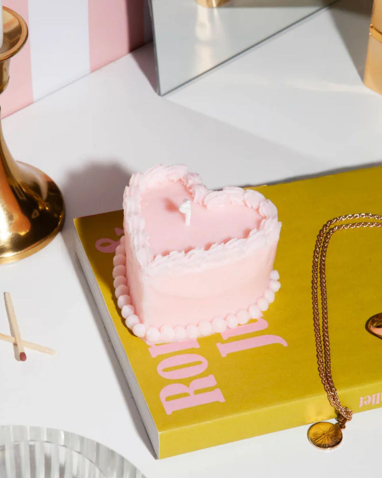 Bougie rose en forme de gâteau avec détails en relief