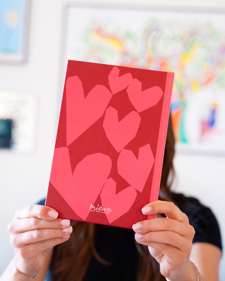 Carnet coloré avec des cœurs, ouvert sur une page blanche