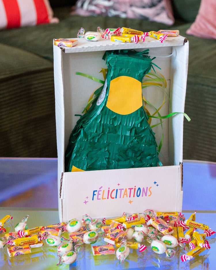 Piñata champagne en forme de bouteille avec bonbons colorés