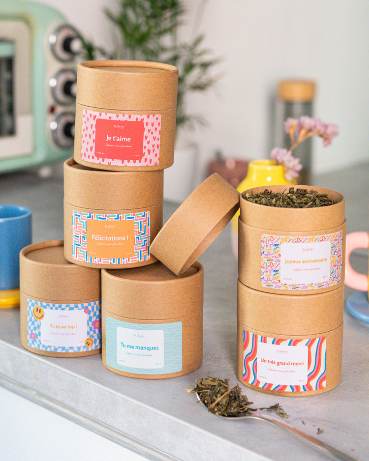 Boîte de thé avec message, vue de face et étiquette colorée.