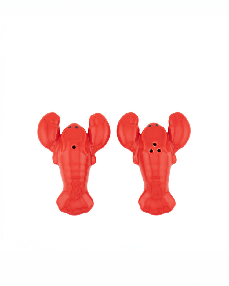 Salière et poivrière en forme de homard sur fond clair