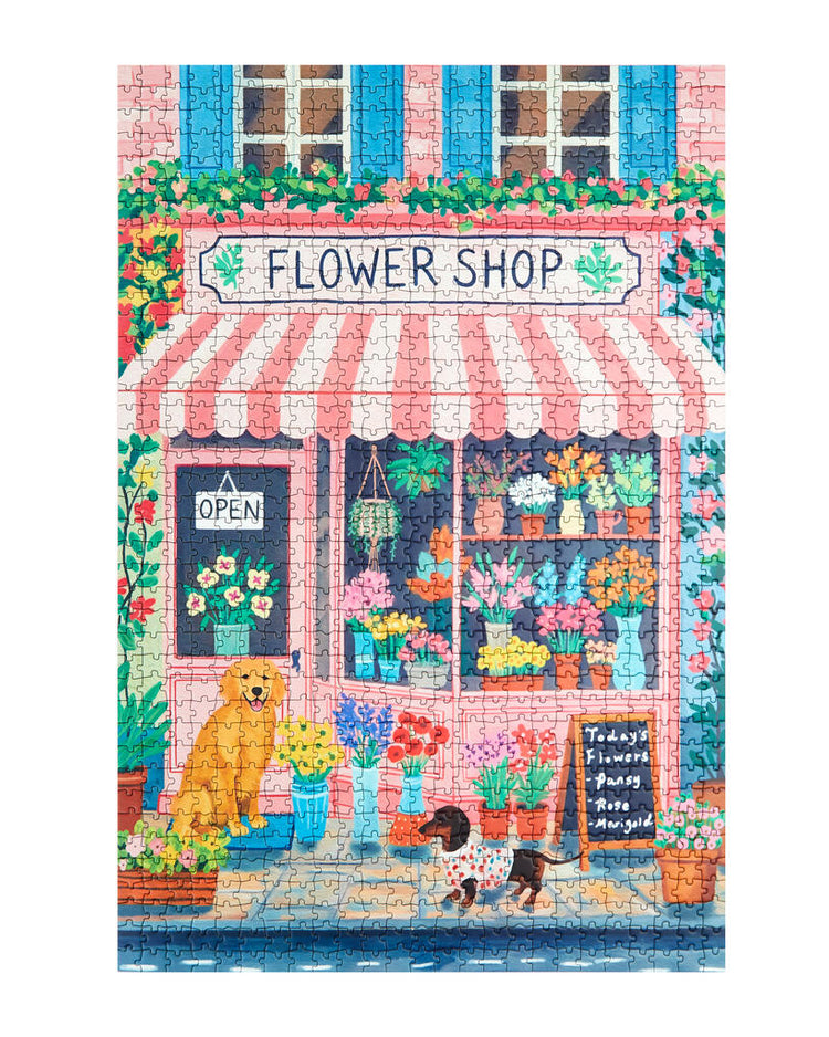 Puzzle représentant un fleuriste avec volets bleus et auvent rayé.