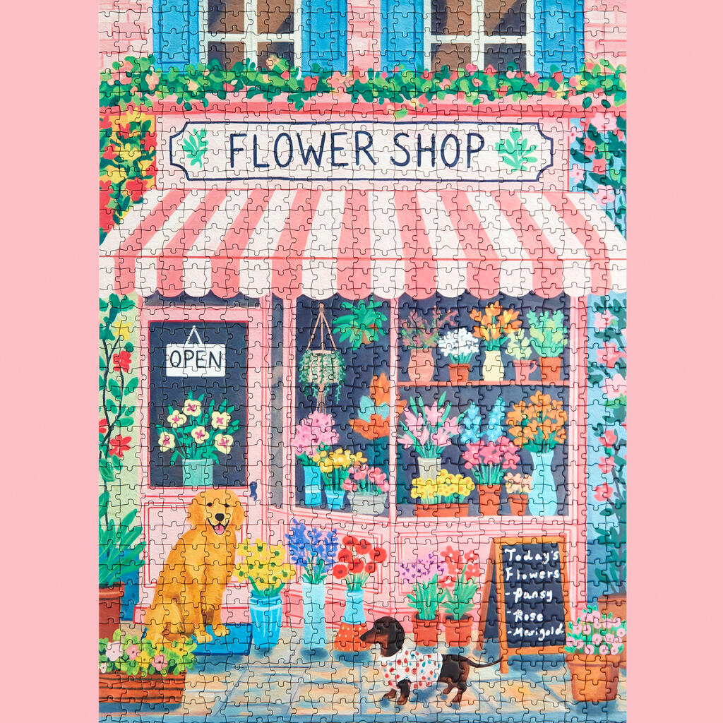 Puzzle représentant un fleuriste avec volets bleus et auvent rayé.