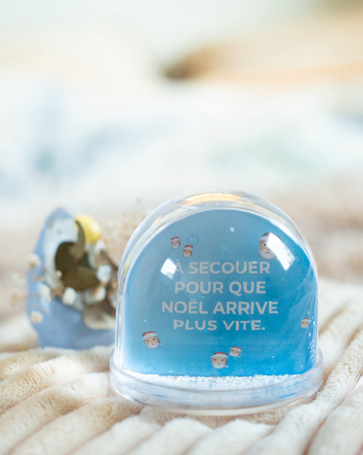 Boule à neige avec flocons scintillants en mouvement